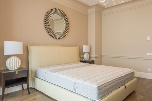 kéo dài tuổi thọ nệm - Spacious bedroom featuring modern decor, elegant lighting, and a plush bed with neutral tones.
